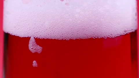 Bright pink foamy fruit cherry beer in the glass close up Stock Footage 303913574