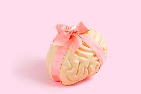 Bright pink human brain model with satin bow on pastel background Stock Photos