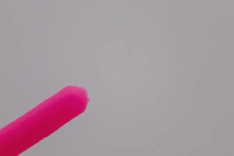 A bright pink object is shown against a light gray background. Stock Photos