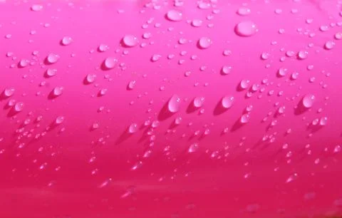 Bright pink paddling pool surface with water drops on it Stock Photos