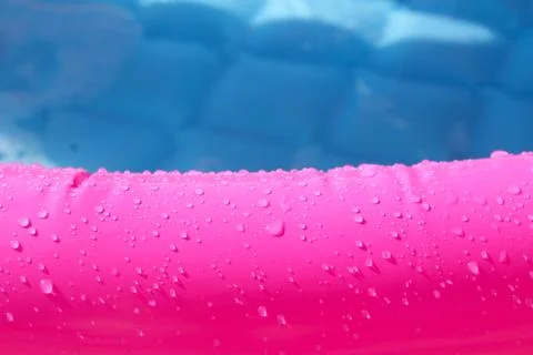 Bright pink paddling pool surface with water drops on it Stock Photos