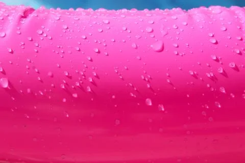 Bright pink paddling pool surface with water drops on it Stock Photos