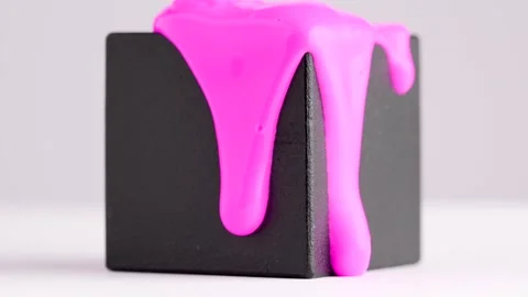 Bright pink paint runs down the black cube. Creative concept. Pink liquid d.. Stock Footage 244642749