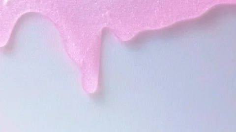 Bright pink transparent  moisturizing face cosmetic gel texture flowing close up Stock Footage 236143440