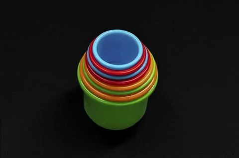 Bright plastic cups nestle in a stack 库存照片
