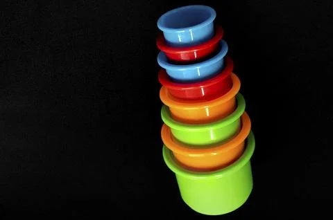 Bright plastic cups stack neatly in a pyramid Stock Photos