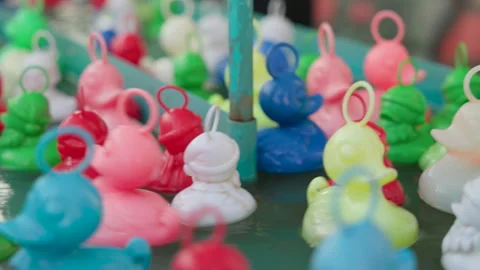 Bright Plastic Ducks Floating in Water at Funfair Kids Game 스톡 동영상 324475416