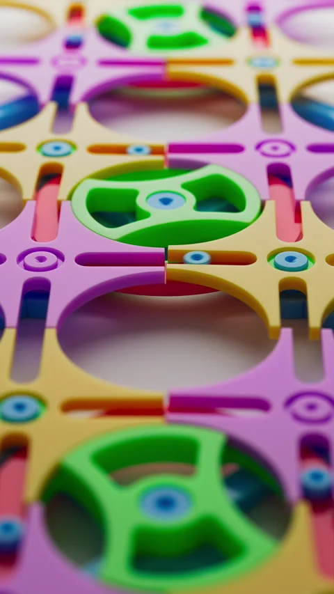 Bright plastic gear components in a colorful construction toy. Stock Footage 314044339