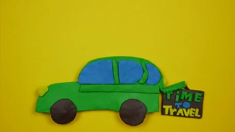 Bright plasticine car. Suitcase in the trunk of a car. Time to travel concept Stock Footage 99657970
