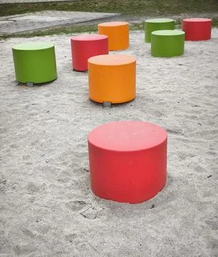 Bright play modules on a sandy playground in a residential area Stock Photos
