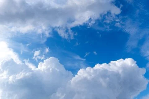 Bright pop blue sky with white clouds Stock Photos