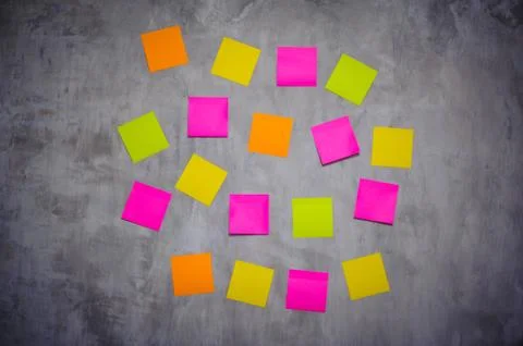Bright post-it notes on grey wall Stock Photos