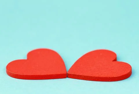 A bright postcard with red macro hearts on a blue background with space for copy Stock Photos