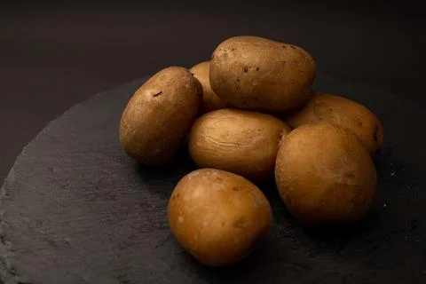 Bright potatoes on a plate Stock Photos