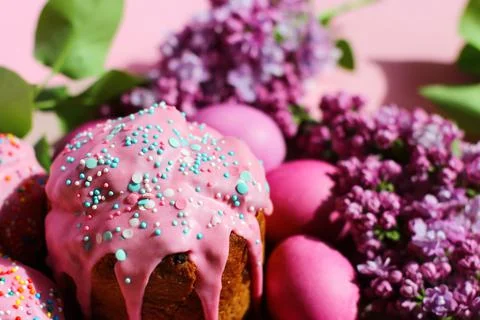 Bright purple easter eggs, cake and lilac flowers on a purple background. Easter Stock Photos