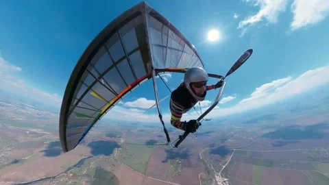 Bright rainbow colored hang glider soars on high altitude Stock Footage 154608193