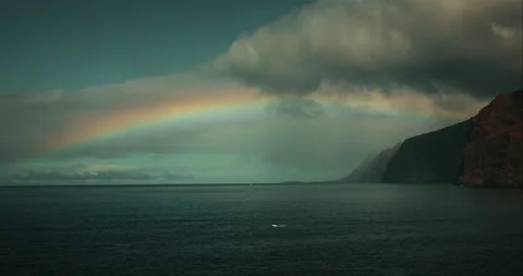 Bright Rainbow Over Ocean Waters and Volcanic Cliffs in Tenerife Spain Stock-Footage 341466653