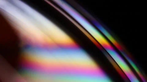 Bright rainbow reflection of liquid on black background Stock Footage 307760624