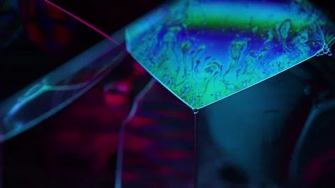 Bright rainbow reflection of liquid in macro, blue background Stock Footage 293151636