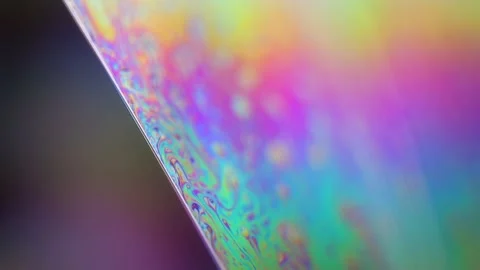 Bright rainbow reflection of liquid in macro, interference pattern Stock Footage 323401032