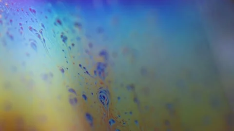Bright rainbow reflection of liquid in macro, interference pattern Stock Footage 323401142