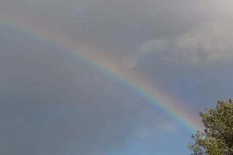 Bright rainbow in the sky with clouds Foto stock