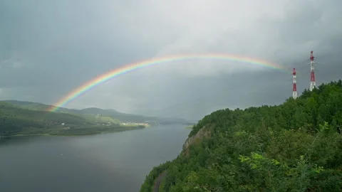 A bright rainbow spread majestically across the grey sky Video stock 301429378