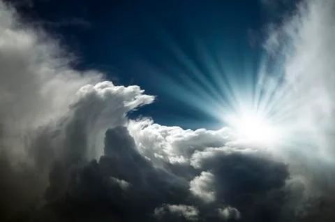 The bright rays of the sun are shining from saturated clouds Stock Photos