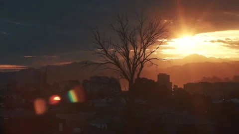 Bright rays of the sun in a dark evening. the night falls on the city Stock Footage 94945699