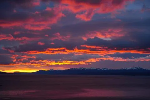 Bright red and orange clouds above the sea at sunset near Ushuaia, Argentina. Stock-Fotos