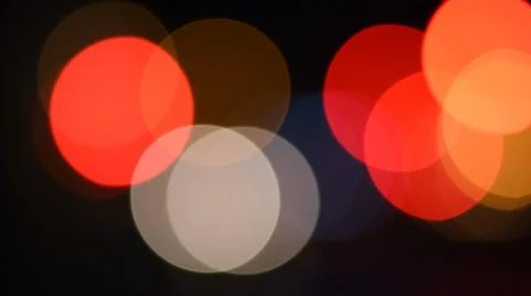 Bright red and orange colors bokeh lights in night darkness Foto stock