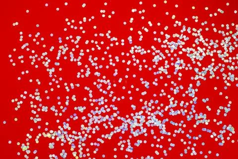 Bright red background with silver sequined hexagons Stock Photos