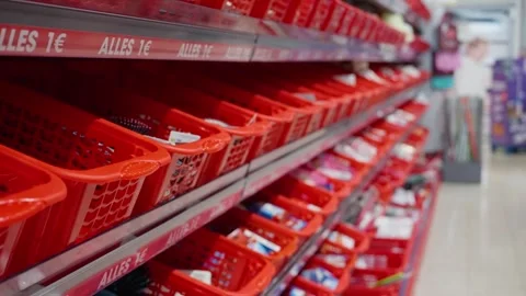 Bright red baskets brim with an assortment of attractive items for sale in a Stock Footage 314894153