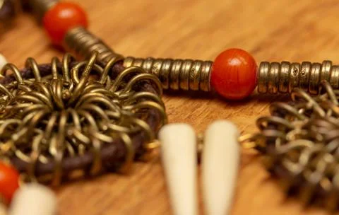 Bright red bead, copper or gold rings and white cones - creepy! Stock Photos