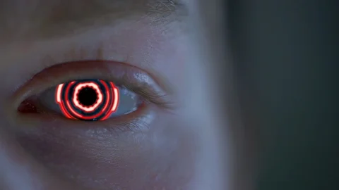 Bright red bionic eye looking at you - close up Stock Footage