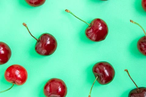 Bright red cherry on a green background Stock Photos