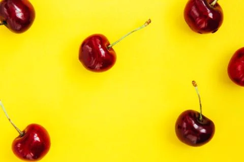Bright red cherry on a yellow background Stock Photos