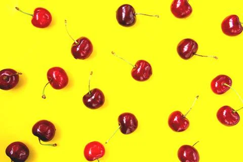 Bright red cherry on a yellow background Stock Photos