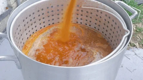 Bright Red Creole Spice Mix Dumps into a Metal Strainer for a Crawfish Boil Stock Footage 74965600