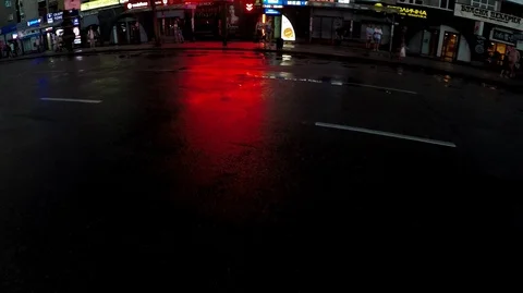 Bright red lights reflect and contrast with wet black asphalt Stock Footage 124482361