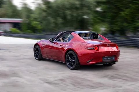 A bright red Mazda cabriolet in motion Stock Photos
