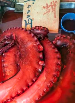 Bright red octopus tentacles in fish market Stock Photos