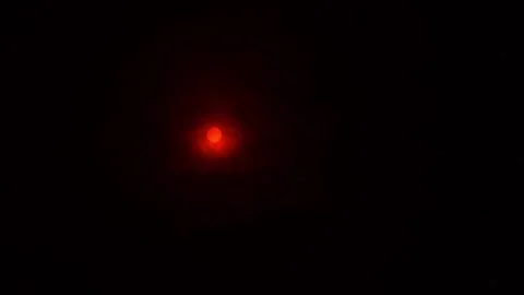 Bright red-orange sun in the black sky, filmed through a sun filter Stock Footage 180968666