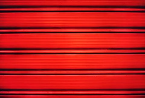 Bright red painted shutter or roller blind. Stock Photos