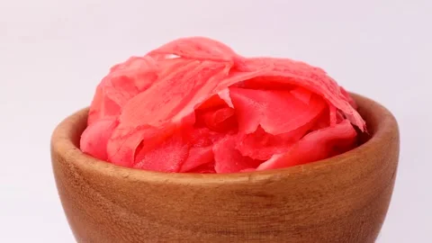 Bright red pickled ginger, rotation in circle. pickled ginger in a wooden bowl Stock Footage 277576867