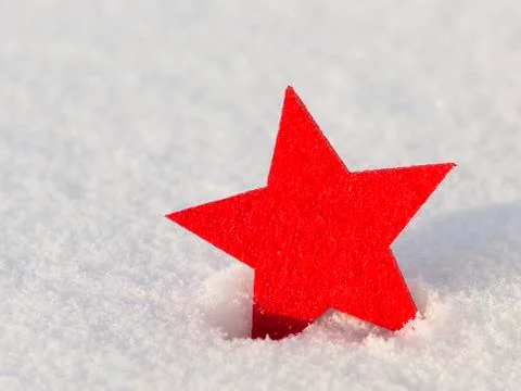 Bright red star in the snow Stock Photos