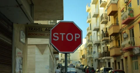 Bright red Stop sign stands tall at side... | Stock Video | Pond5