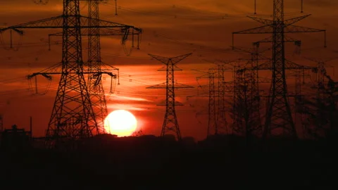 Bright red sunset with power lines and electrical towers in the sky Video stock 164783205