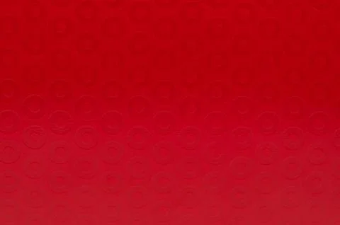 Bright red surface with circular patterns seen close up Stock Illustration