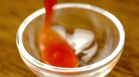 Bright red tomato sauce squeezing out into dipping bowl Stock Footage 62851637